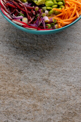 Overhead view of hawaiian poke bowl with copy space on grey background
