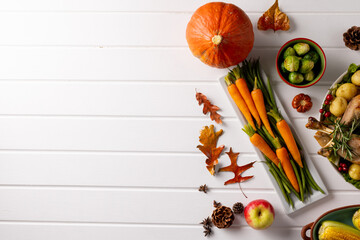 Overhead view of thanksgiving table with roast turkey, vegetables autumn decoration and copy space