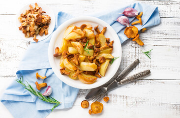 Potatoes with Chanterelle Mushrooms and Rosemary on White Wooden Background