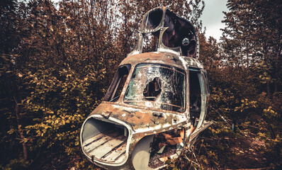 Abandoned old destroyed cabin of soviet union helicopter with broken glass lost in the wild nature