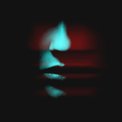 Abstract fashion concept. Woman face in black shadow background with copy space in red and blue...