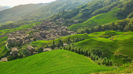 Fototapeta na wymiar Top view of the village in the mountains. Terraced fields. Winding road. China. Picturesque landscape. Panorama.
