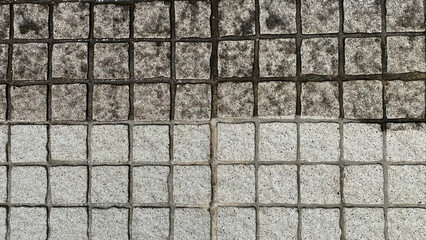 Before and after, washing an outdoor floor in gray granite bricks