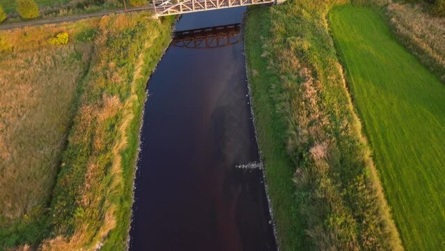 Old steel tram bridge over the Ner River in the city of Lutomiersk, Poland.