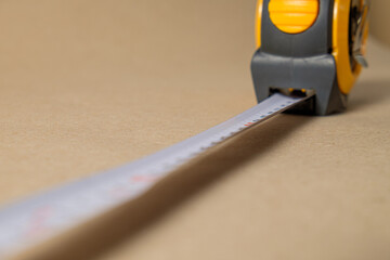 Cartridge meter. Yellow measuring tape isolated on craft paper background. With
 space for text