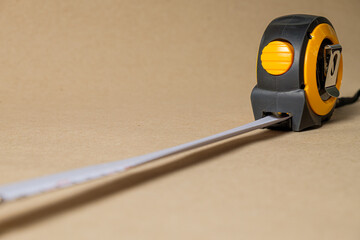 Cartridge meter. Yellow measuring tape isolated on craft paper background. With
 space for text