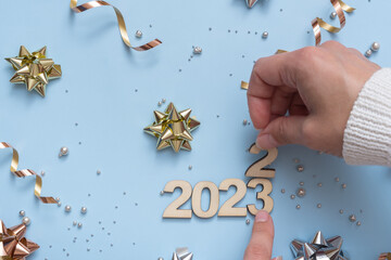 The numbers of the old year 2022 have been replaced by the new 2023 on a bright festive background...
