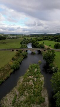Vertical aerial footage of River Wharfe and Pool Bridge, West Yorkshire