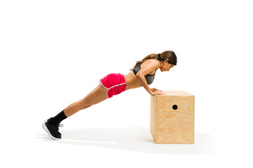 Active fit woman doing push up on jump box in cross training