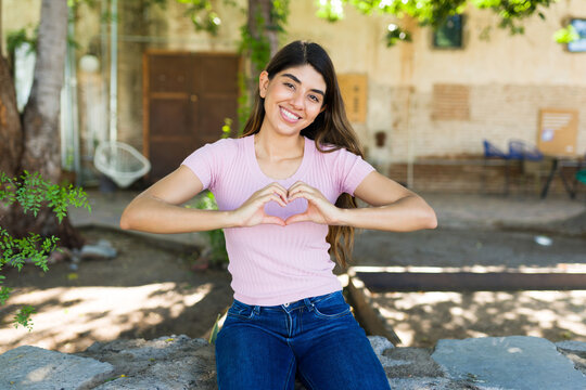 Loving latin woman making a heart with her hands