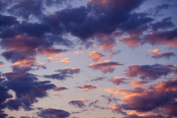 Beautiful sunset sky above clouds with dramatic light. Abstract nature background. Dramatic and moody pink, purple and blue cloudy sunset sky