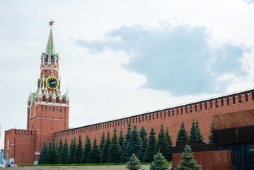 Moscow Kremlin wall with the Spasskaya Tower and Lenin's Mausoleum on Red Square in summer day.