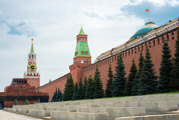 Moscow Kremlin wall with the Spasskaya Tower and Lenin's Mausoleum on Red Square in summer day.