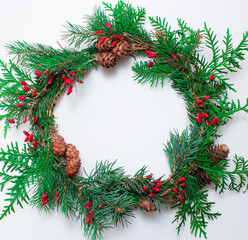 Fototapeta na wymiar Christmas wreath made of natural shrubs and berries, for the design of banners and postcards for the new year and Christmas.