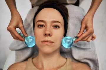 Facial massage with cold spheres.