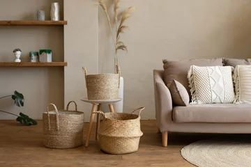 Fotobehang Boho Various wicker baskets for interior decoration stand on the floor in a modern living room.  © July P
