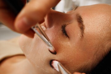 Face massage with brushes.