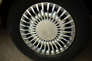 Car wheel. Hubcap on wheel. Vehicle tuning details. Drive wheel. Retro style.