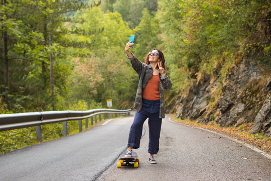 girl takes a selfie of herself on her skateboard