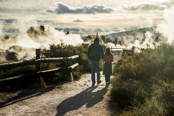 people in geothermal volcanic park with geysers and hot streams, scenic landscape, te piua national...