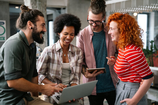 Diverse Group Of Professionals Meeting In Office. IT Programmers Use Computer, Talk Strategy