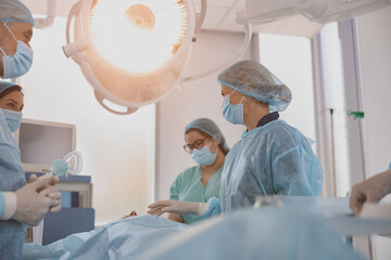 Concentrated surgical team working with a patient in an operation room