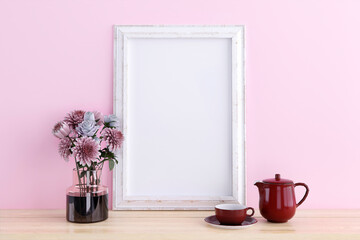 Mockup picture frame on a wooden cabinet. 3d rendered illustration.
