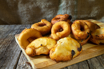 Homemade pies and donuts lie on a wooden board