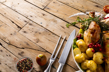 Naklejka premium Overhead view of thanksgiving table with roast turkey, potatoes and copy space on wood