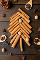 Image of christmas decoration with spices forming christmas tree on wooden background