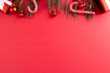 Image of christmas decoration and copy space on red background