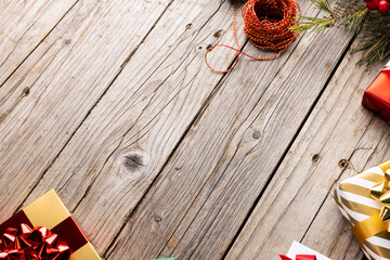 Image of christmas decoration with gifts and copy space on wooden background