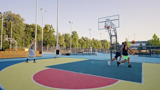Bald man shoots ball into basket after fail making goal