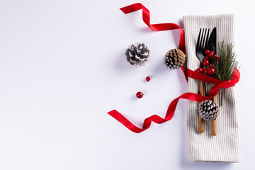 Image of christmas place setting with cutlery and copy space on white background