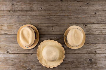 Image of straw hats lying on wooden surface