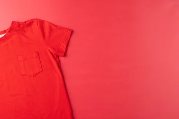 Foto op Canvas Image of red tshirt lying on red surface © vectorfusionart