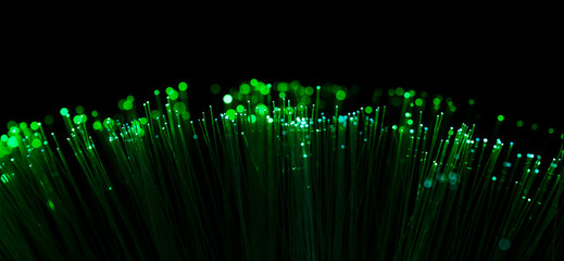 Fiber optic filaments that emit green light