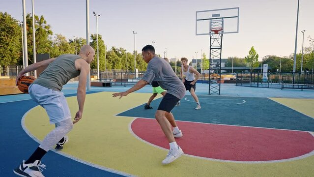 Man teases opponent shooting ball into basket at basketball