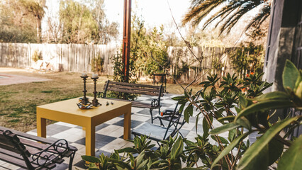 home garden with wooden benches, white and black floor, backyard, spring
