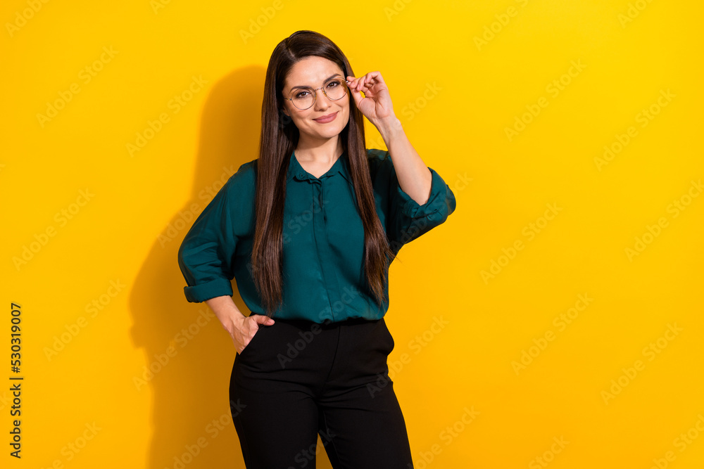 Wall mural Photo of smart clever lady dressed green shirt arm glasses smiling empty space isolated yellow color background