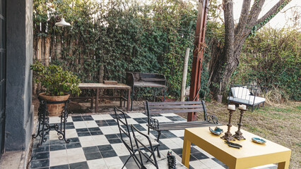 home garden with wooden benches, white and black floor, backyard, spring