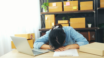 Desperate Asian woman stress headache depressed from startup small business at home office. Failure...