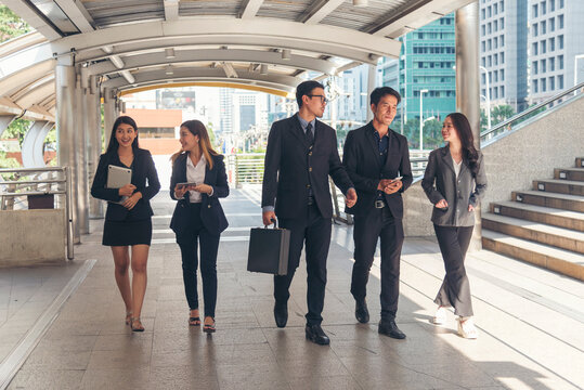 Crowd business people walking go to work in modern city life to working office. Crowd worker group of people busy life with businesswoman,  man in urban street city lifestyle. Business People Concept.