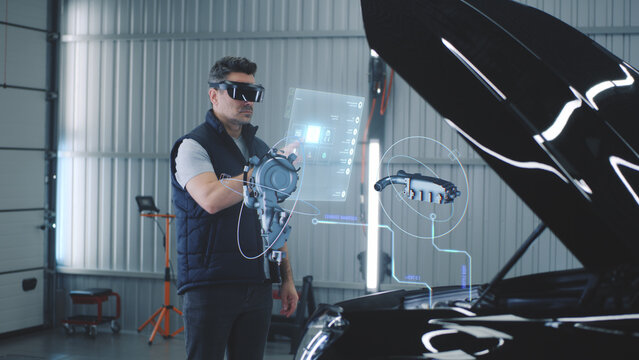 Car service manager conducts car diagnostics using holographic hud interfaces and vr headset. The specialist studies the serviceability of the engine and other parts of the car in 3D cyber space.