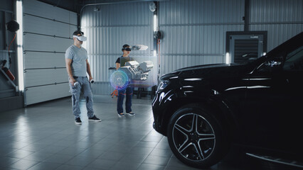 Two technicians check a car engine using virtual reality technology in a workshop. Experts discuss...