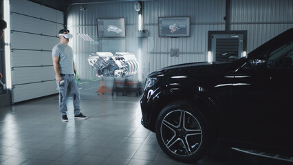 Car service manager assembling a car engine in a futuristic virtual reality program using a joystick and a virtual reality helmet
