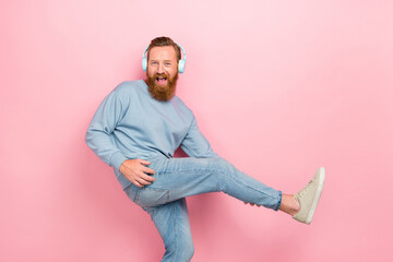 Profile portrait of overjoyed cheerful man listen new playlist hands hold leg play guitar isolated on pink color background