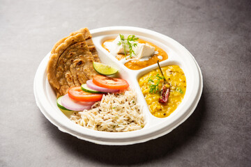 North Indian mini meal, parcel platter or combo thali with paneer butter masala, roti, dal and rice