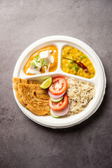 North Indian mini meal, parcel platter or combo thali with paneer butter masala, roti, dal and rice
