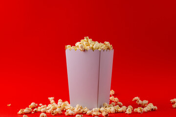 Image of pop corn in box on red surface